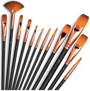 Set of assorted artist paintbrushes with copper ferrules – essential art tools .